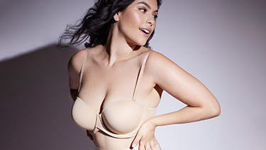 woman wearing a bra looking back over shoulder