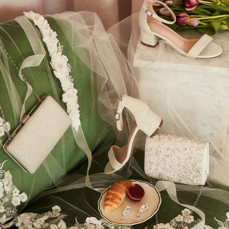 shoes, clutches, sash, and earrings on a chair