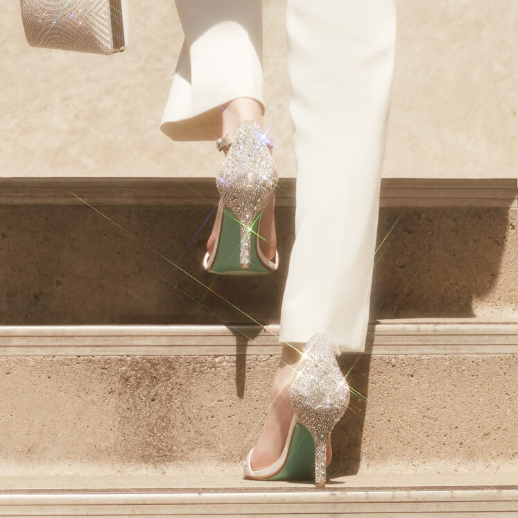woman walking up steps in metallic stiletto shoes