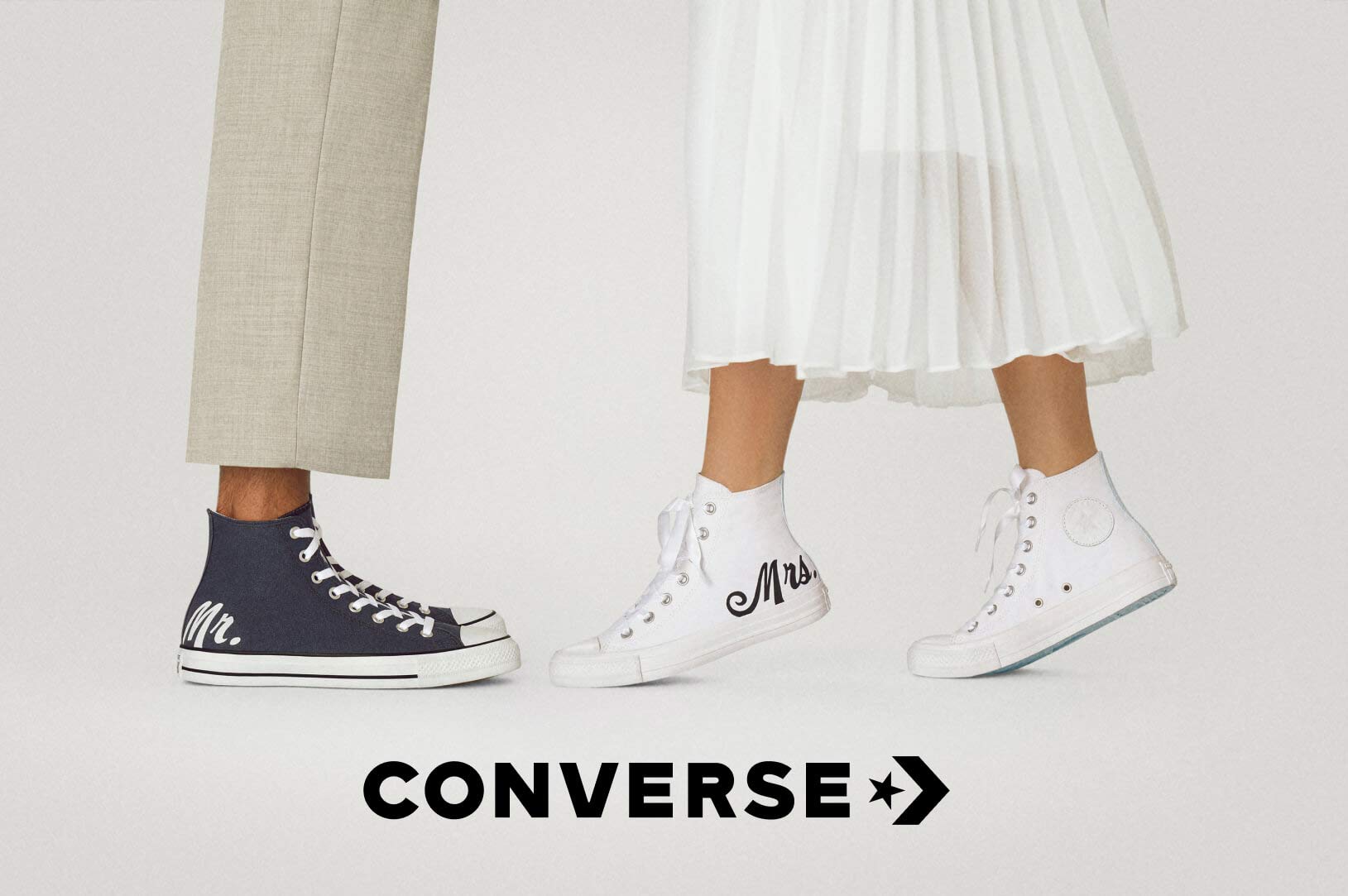 bride and groom wearing mr. and mrs. sneakers with converse logo overlay