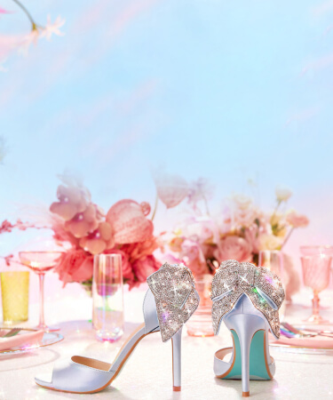 high heel shoes, champagne glasses, and flowers on a table