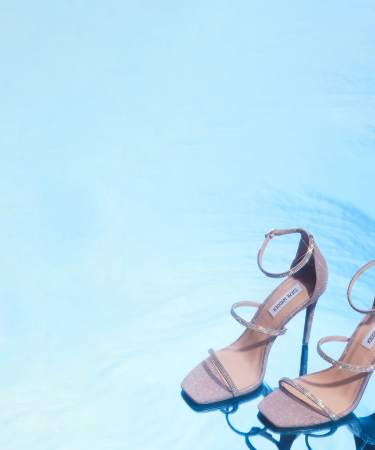 pair of steve madden shoes on a blue floor and background