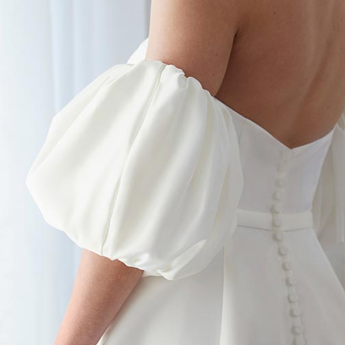 back of bride wearing a wedding dress with sleeves