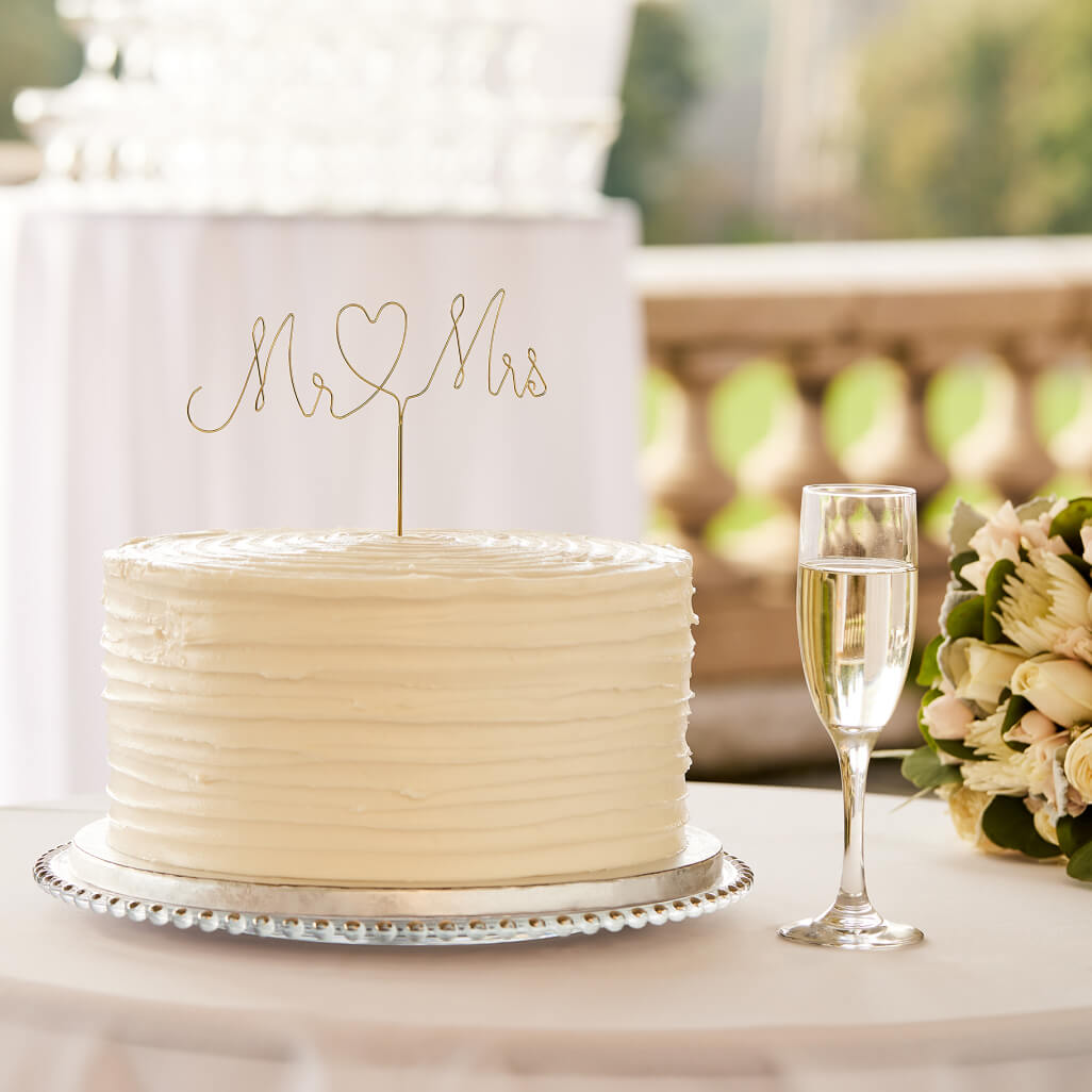 wedding cake and champagne glass on a table