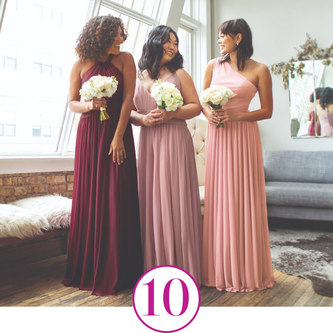 3 bridesmaids holding bouquets and standing in an apartment