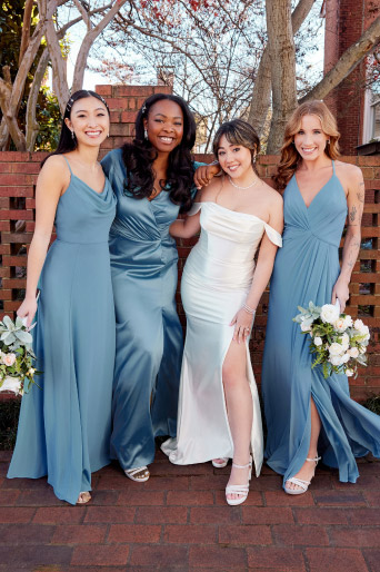group of bride and bridesmaids in blue bridesmaid dresses