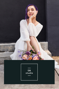 bride in db studio holding bouquet and sitting on a step promoting the db studio brand