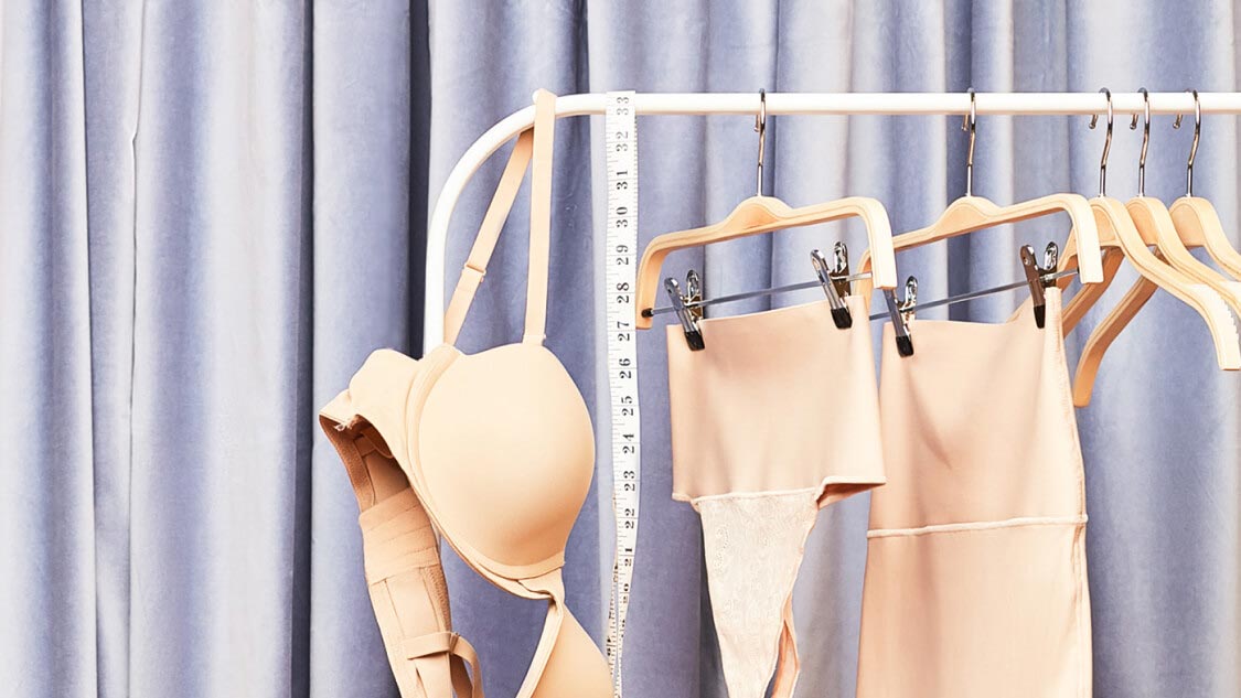 multiple pieces of undergarments hanging on a rack