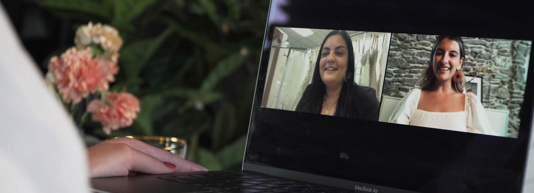 bride on a virtual appointment with a store associate on a laptop