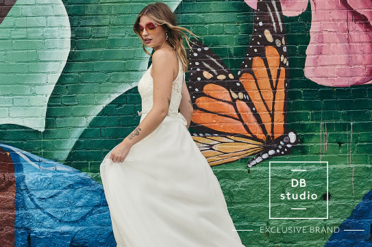 db studio bride walking in front of a mural