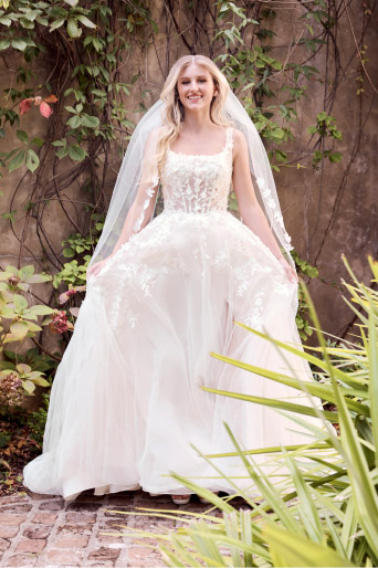 woman in wedding dress outside in a garden