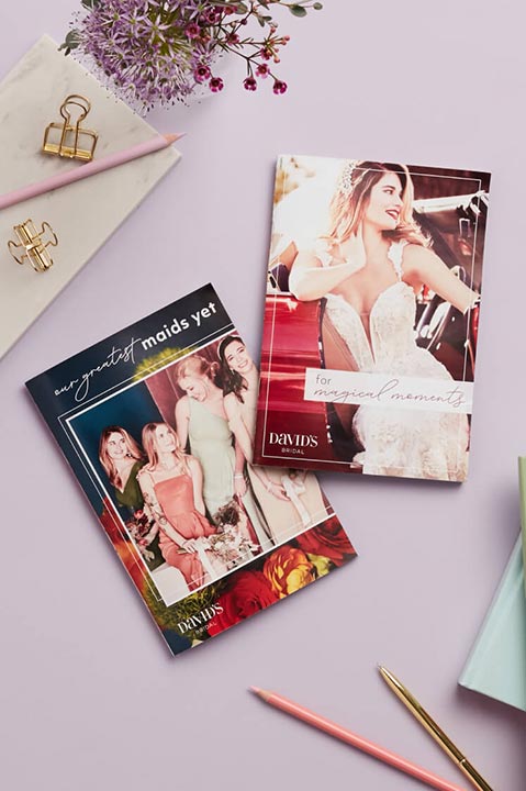 david's bridal catalogs on a desk with office supplies