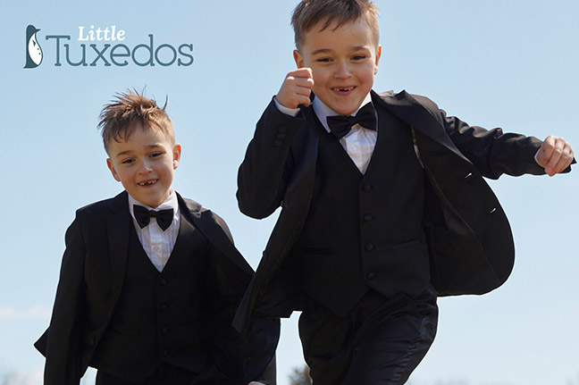 two boys running wearing tuxedos and bow ties