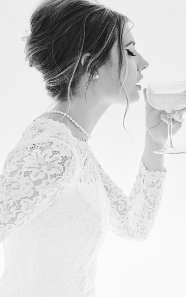 closeup of a bride sipping champagne