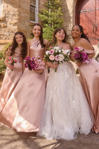 bride with her bridesmaids holding bouqets