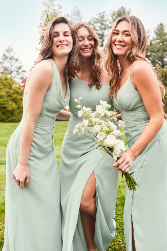 3 bridesmaids in dusty sage charm dresses posing and smiling