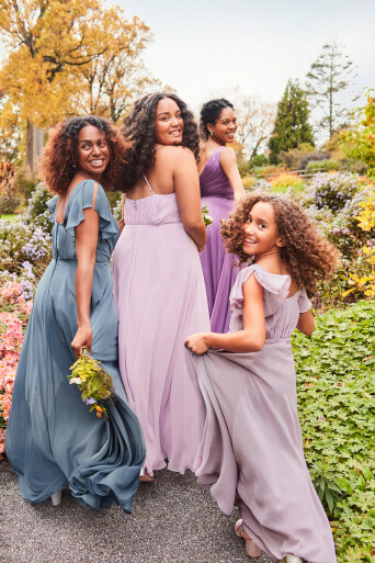 3 bridesmaids and a junior bridesmaids in daydream dresses looking behind them