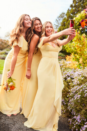 3 bridesmaids in canary lively dresses posing for a selfie
