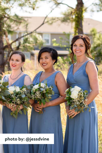 3 bridesmaids outside holding bouquets