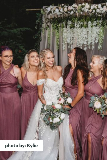 bridal party laughing and posing for a photo