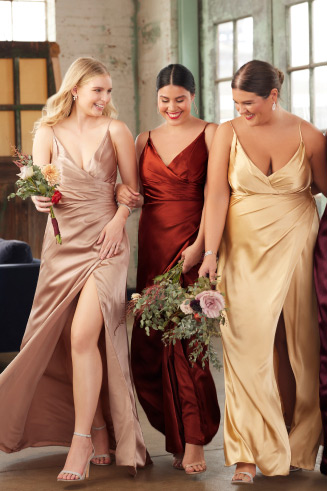 3 bridesmaids holding bouquets and smiling