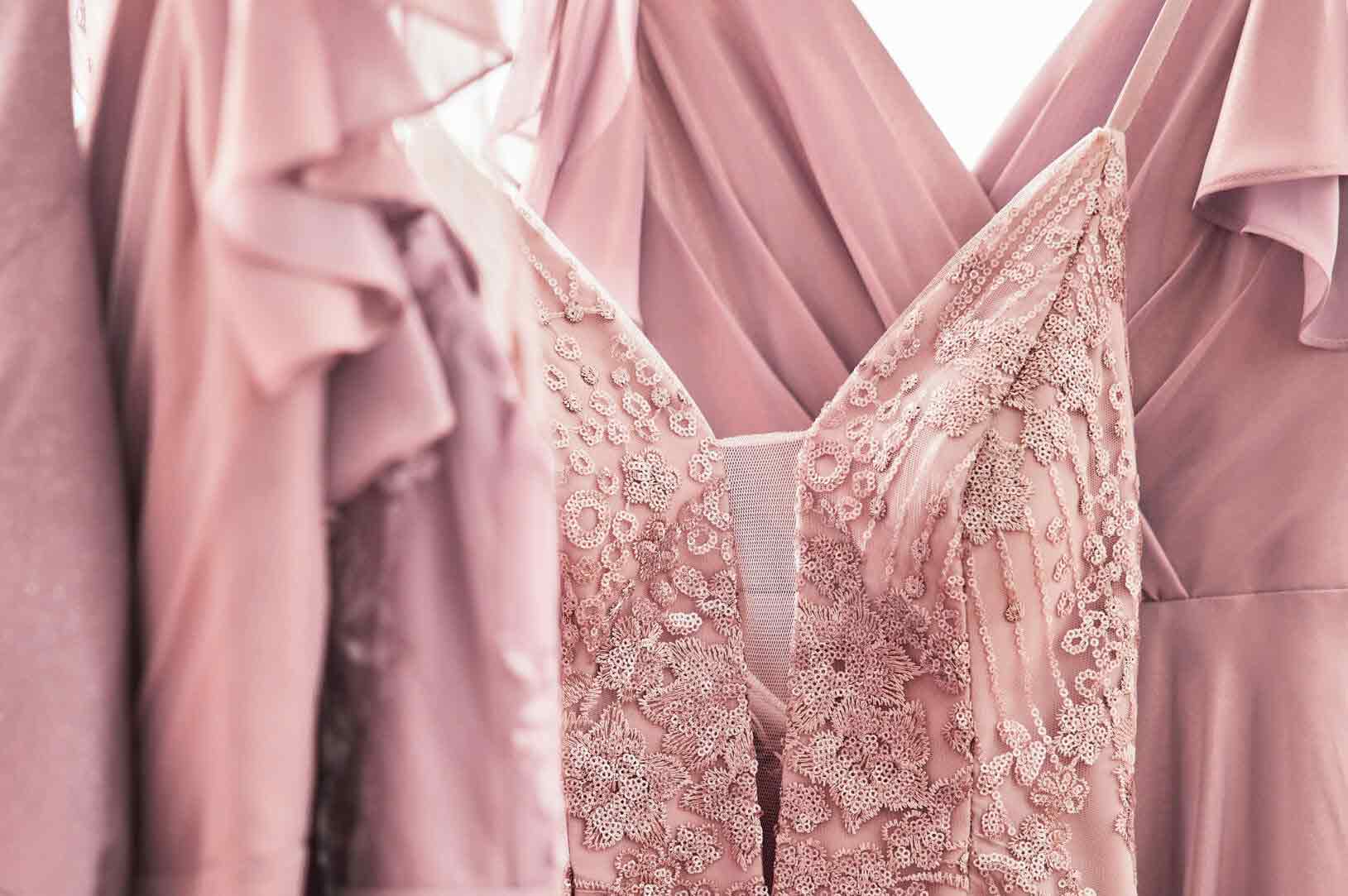 pink dresses hanging on a dress rack