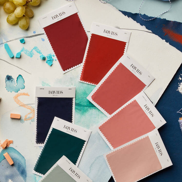 multiple different color dress swatches spread out on a table