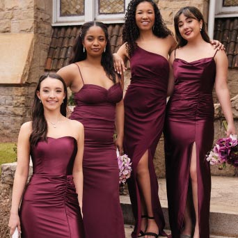 four bridesmaids in wine standing on steps