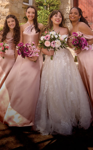 bride with all of her bridesmaids holding bouquets