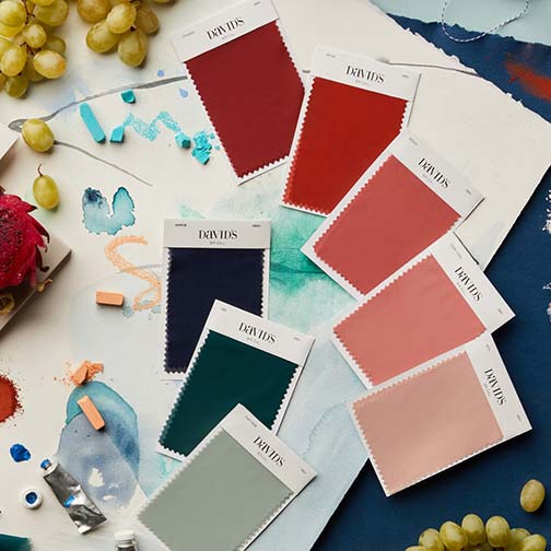 color swatches on a table with watercolors and grapes