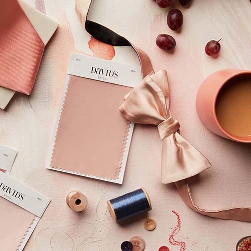 natural toned color swatches on a table with a bow tie and coffee