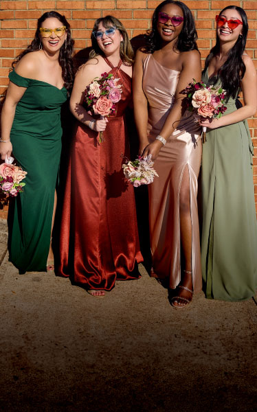 group of four bridesmaids wearing sunglasses and holding bouquets