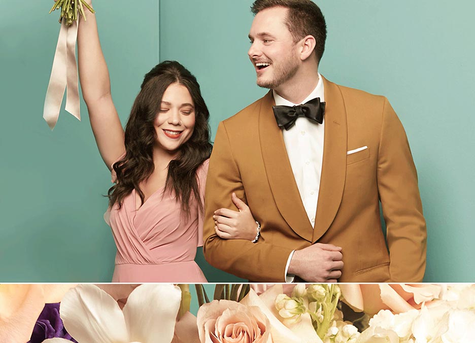 groomsman wearing a gold tuxedo jacket and bow tie with arms locked with a bridesmaid in a pink dress
