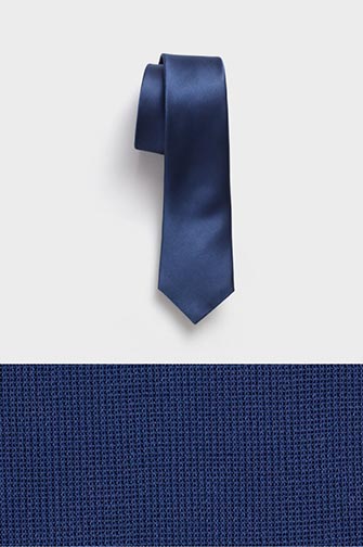 navy colored neck tie on top of a navy colored fabric swatch