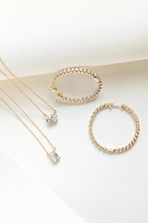 diamond earrings and necklaces displayed on a table