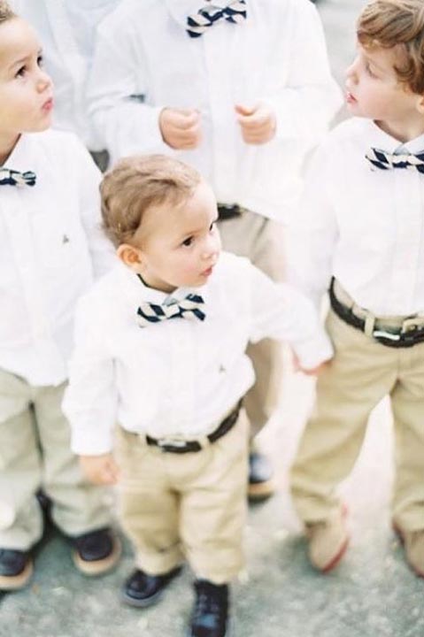 group of boys wearing dress shirts, bow ties, and khakis