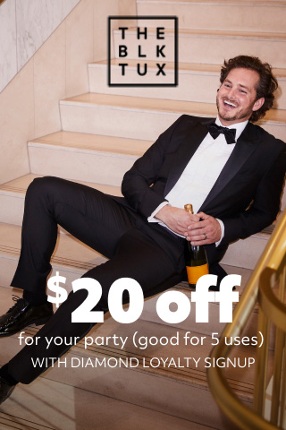 groom laying on the steps holding a champagne bottle promoting the black tux $20 off for your party (good for 5 uses) with diamond loyalty signup