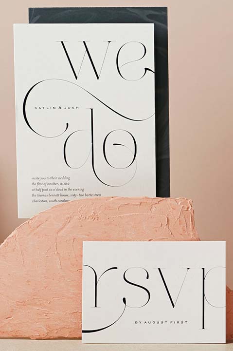 wedding invitation and response card with a pink colored stone