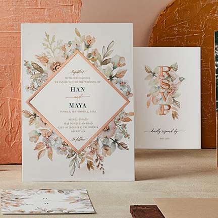wedding invitation and response card on a table