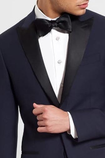 man wearing midnight tuxedo jacket and black bowtie