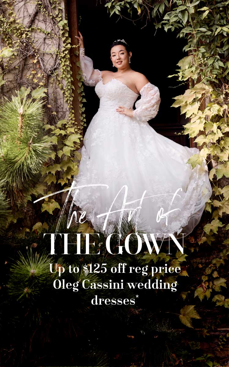 woman in wedding dress posing in garden promoting the art of the gown up to $125 off reg price oleg cassini wedding dresses*